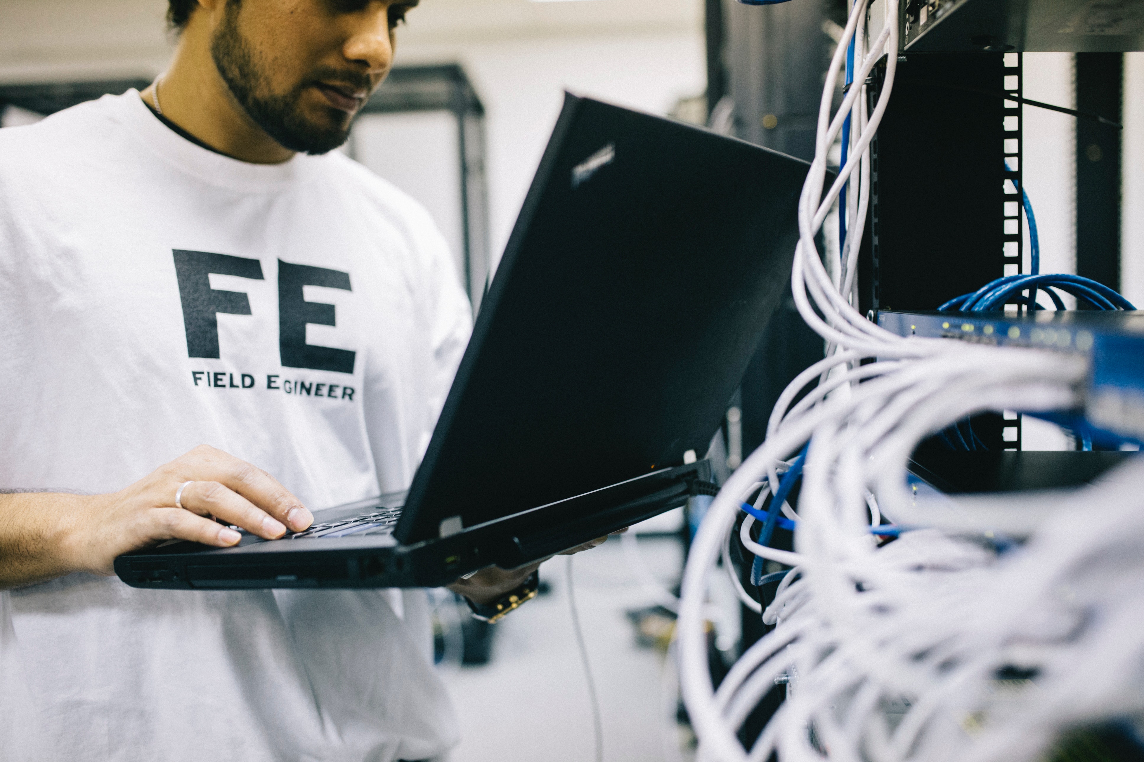 Network engineer working with cabling and laptop